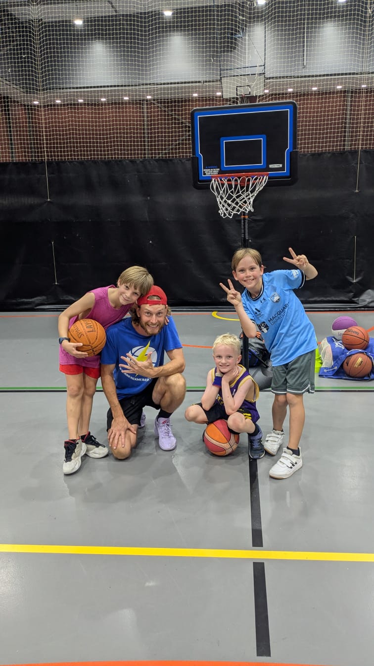 Kids learning basketball skills at NCIE Redfern